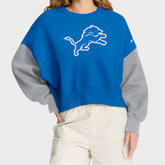 Person wearing a blue and gray sweatshirt with a logo on a white background