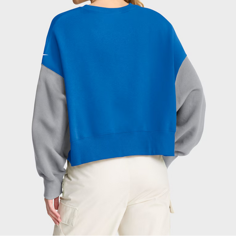 Person wearing a blue and gray sweatshirt on a white background